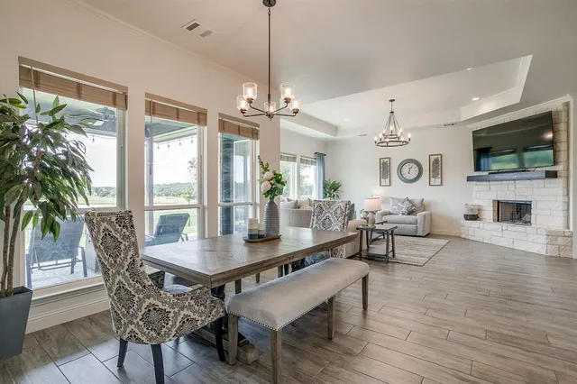 a dining room with furniture window and wooden floor
