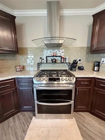 a stove top oven sitting inside of a kitchen