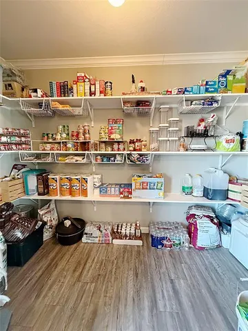 a room with lots of clutter and wooden floor