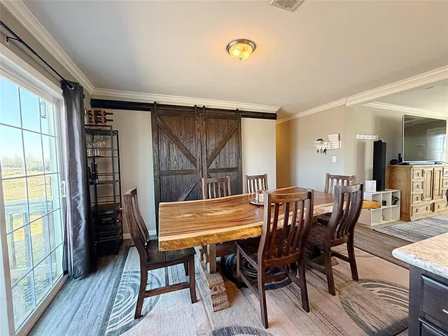 a view of a dining room with furniture and wooden floor