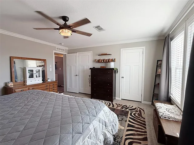 a bedroom with a bed and a large mirror