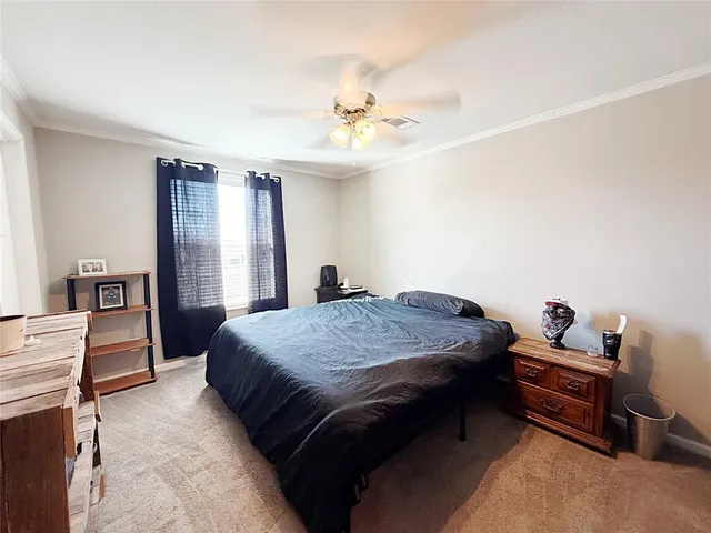 a bedroom with bed and window