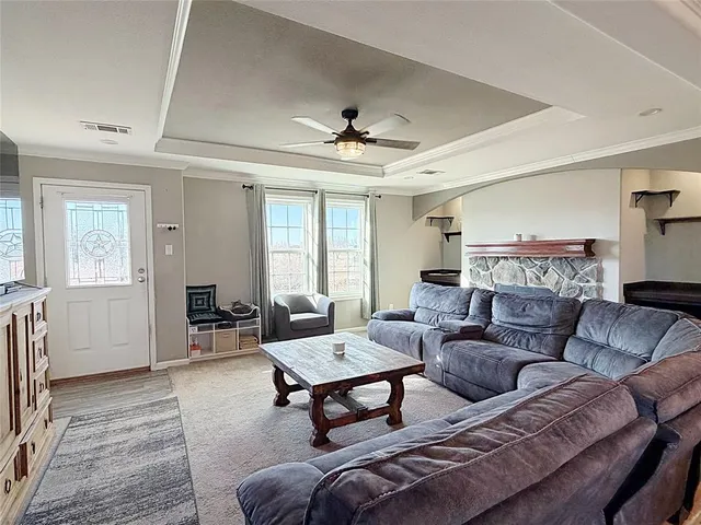 a living room with furniture and a fireplace