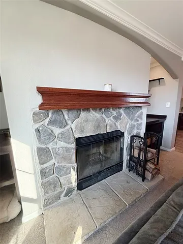 a fireplace with sitting area in front of it