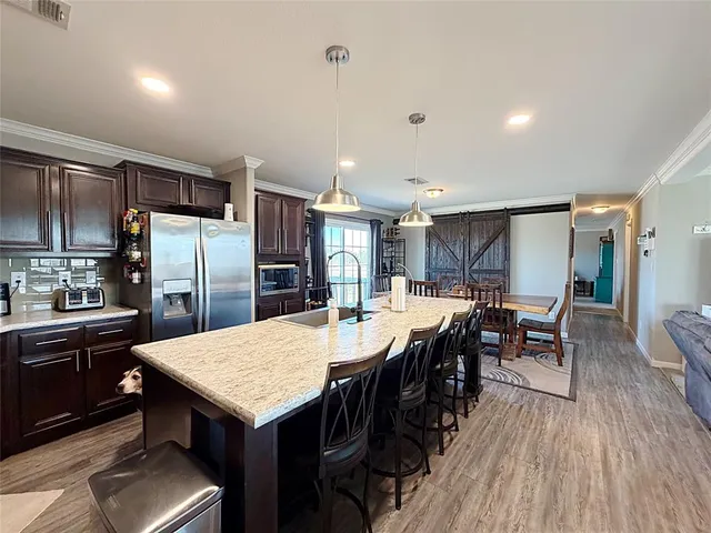 a large kitchen with a table and chairs