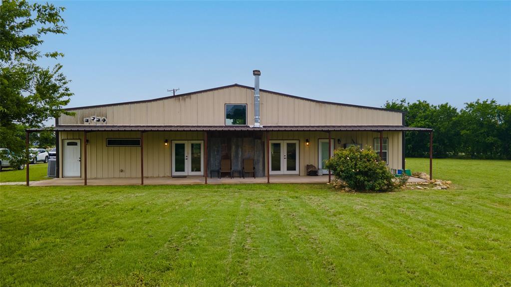a view of a house with a yard and sitting area