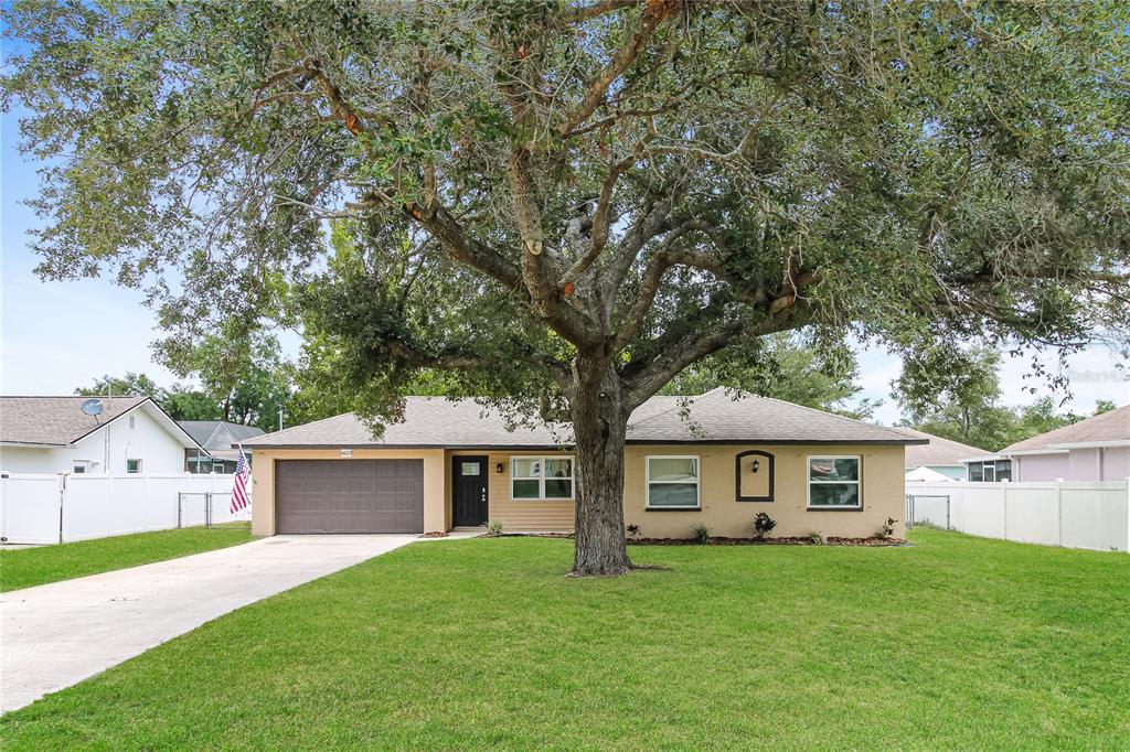 Undisclosed Address Spring Hill, FL 34608 - Photo 1 of 1 a front view of a house with a garden