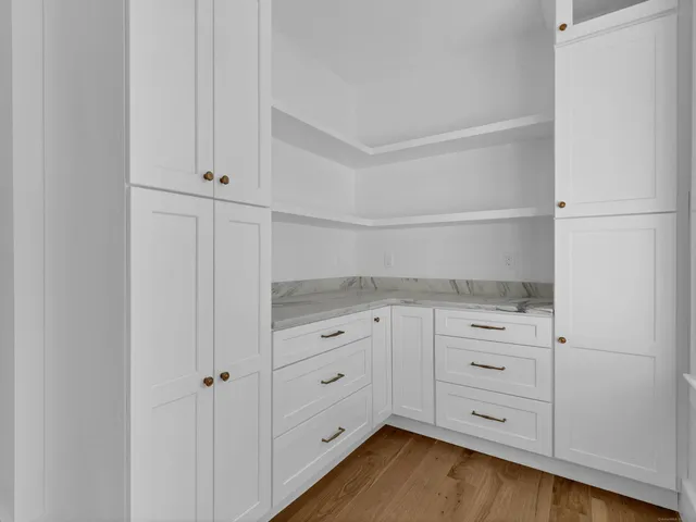 a kitchen with white cabinets and white appliances