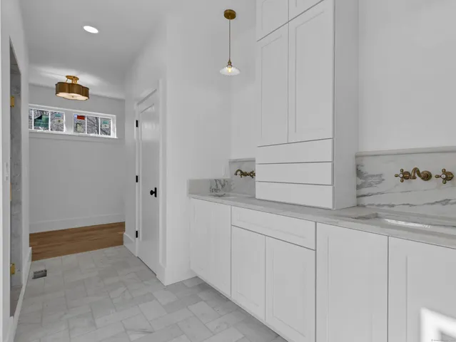 a bathroom with a sink and cabinets