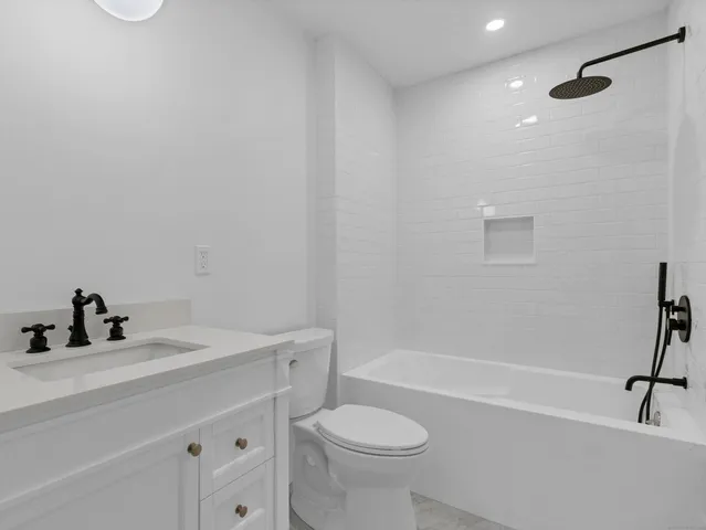 a bathroom with a sink a toilet and a bathtub