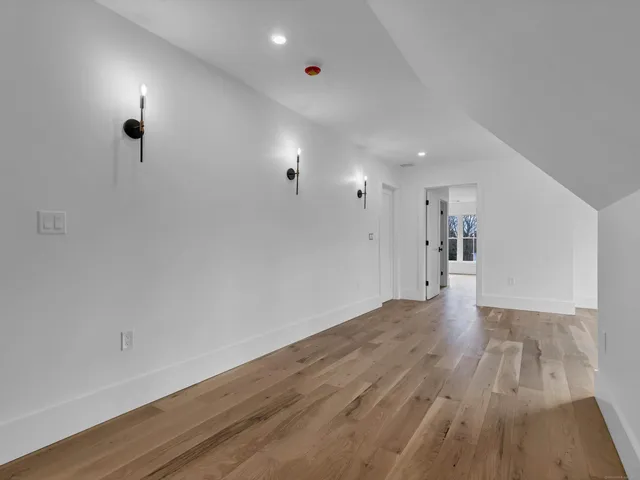 a view of a room with wooden floor and a window