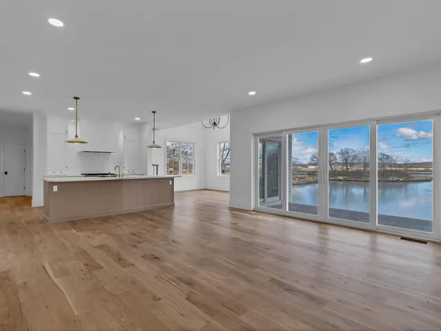 a view of kitchen with wooden floor and windows