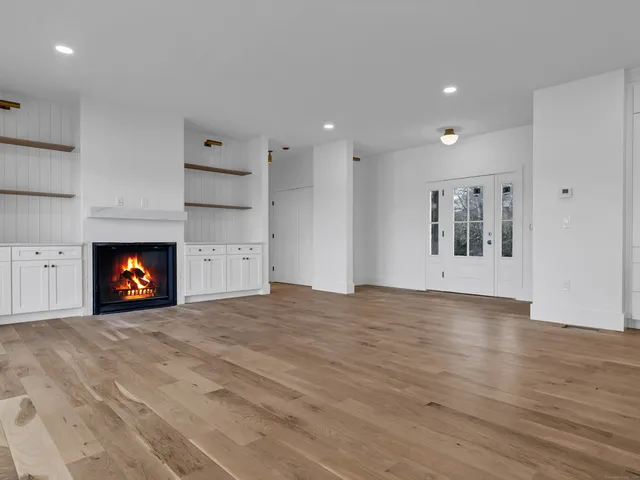 a view of an empty room and fire place