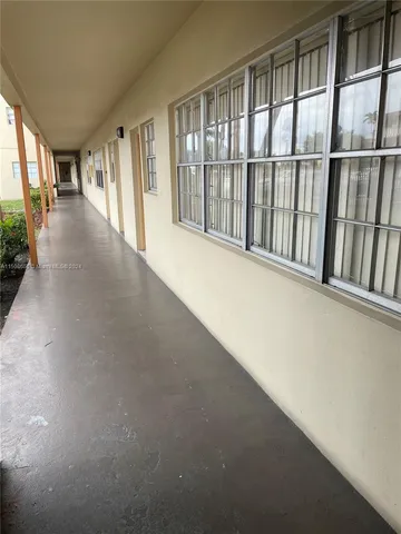 a view of hallway with wooden floor