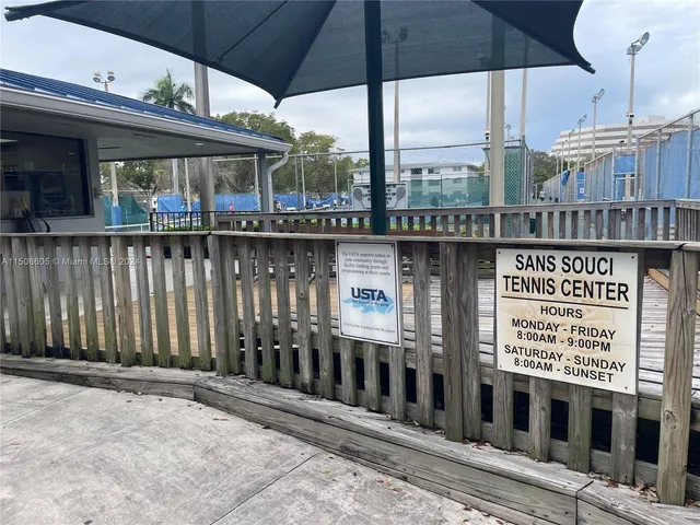 a view of a patio with swimming pool and table and chairs