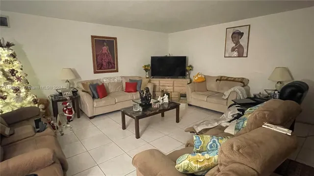 a living room with furniture a couch and a flat screen tv
