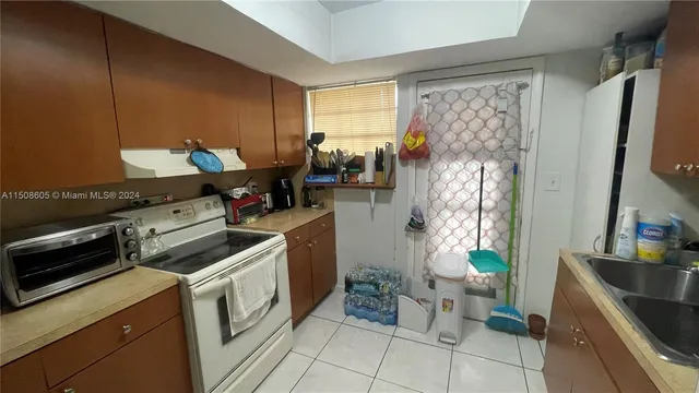 a kitchen with stainless steel appliances a stove a sink and a refrigerator