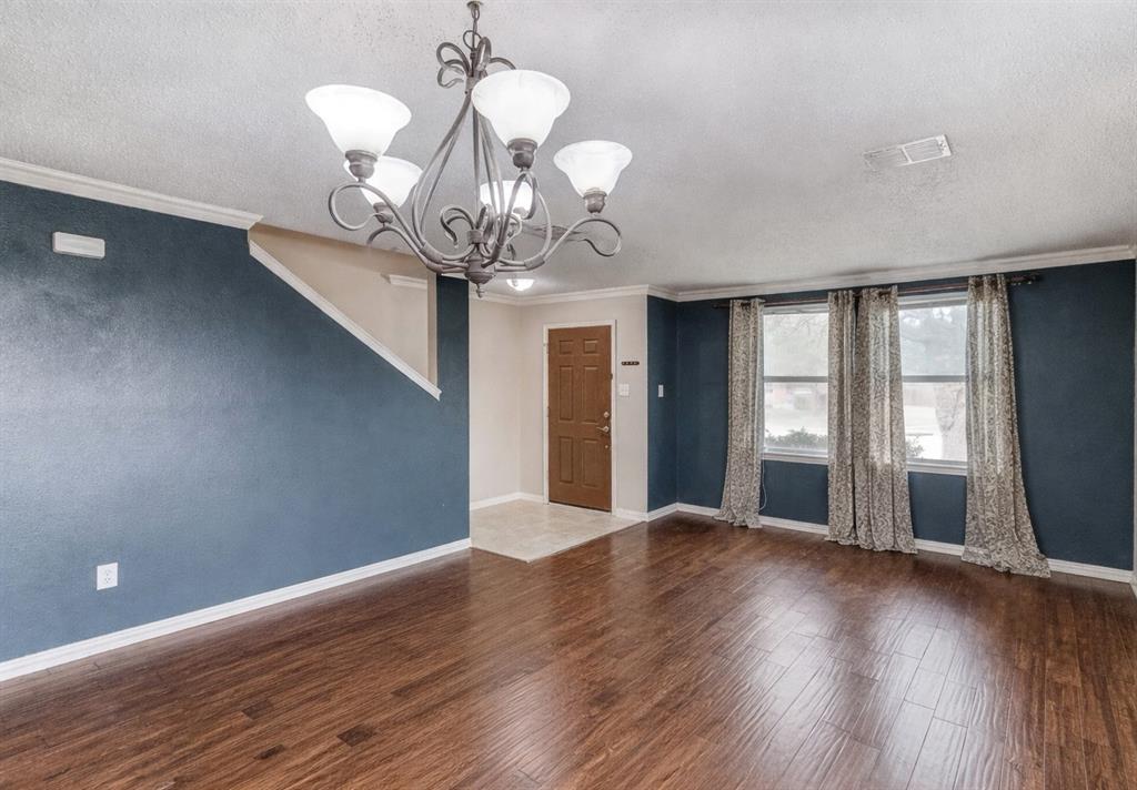 3601 McClintick Road McKinney, TX 75070 - Photo 4 of 24 a view of an empty room with wooden floor and a window