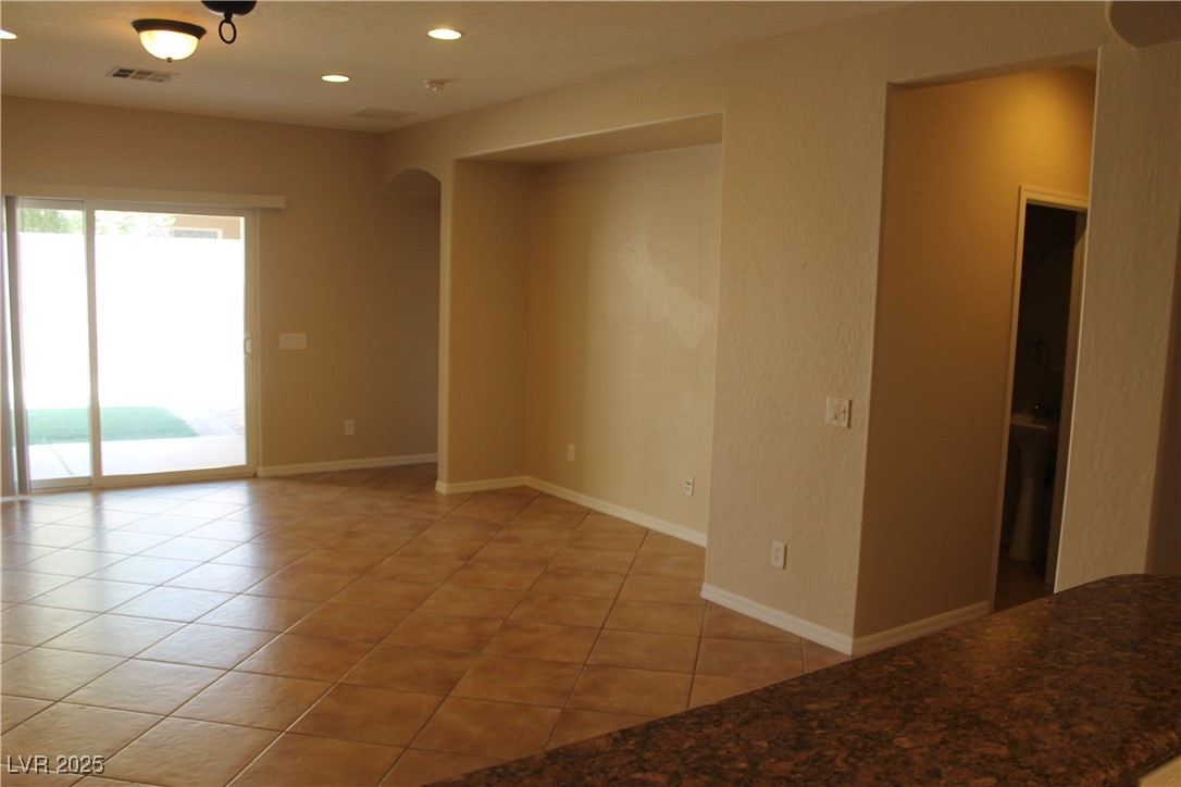 7352 Ravines Avenue Las Vegas, NV 89131 - Photo 12 of 93 Spare room with light tile patterned flooring, arched walkways, and recessed lighting