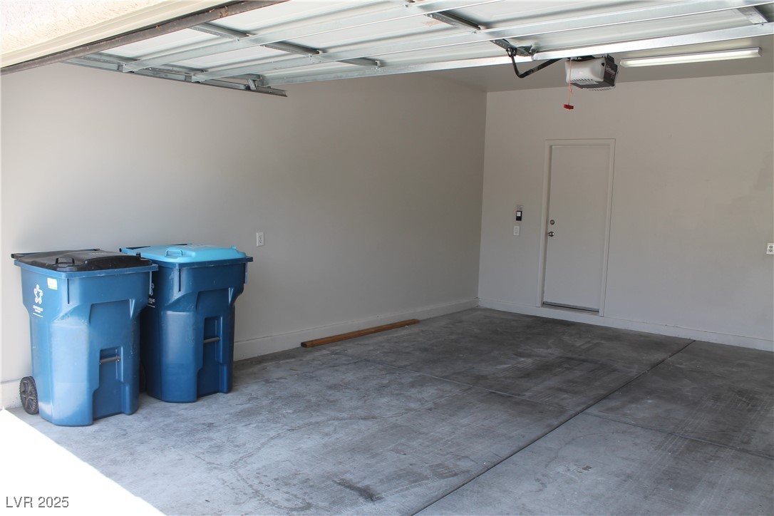 7352 Ravines Avenue Las Vegas, NV 89131 - Photo 30 of 93 Garage featuring baseboards and a garage door opener