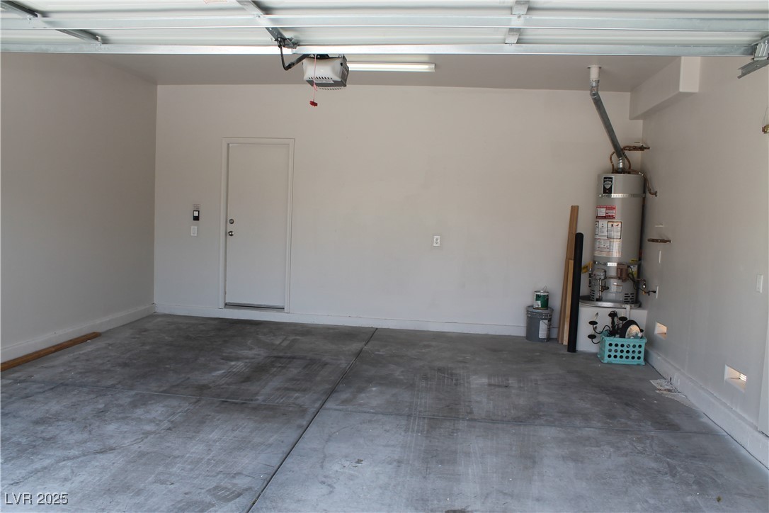 7352 Ravines Avenue Las Vegas, NV 89131 - Photo 32 of 93 Garage with secured water heater and a garage door opener