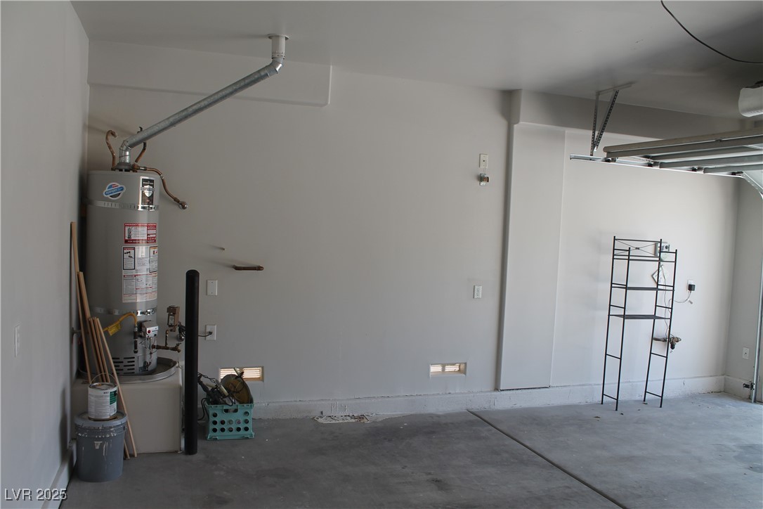 7352 Ravines Avenue Las Vegas, NV 89131 - Photo 33 of 93 Garage with water heater and a garage door opener