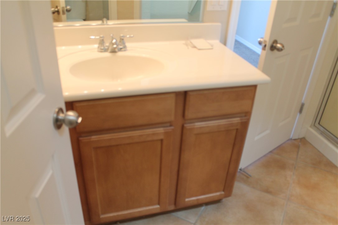 7352 Ravines Avenue Las Vegas, NV 89131 - Photo 39 of 93 Bathroom featuring vanity, light tile patterned floors, and a stall shower
