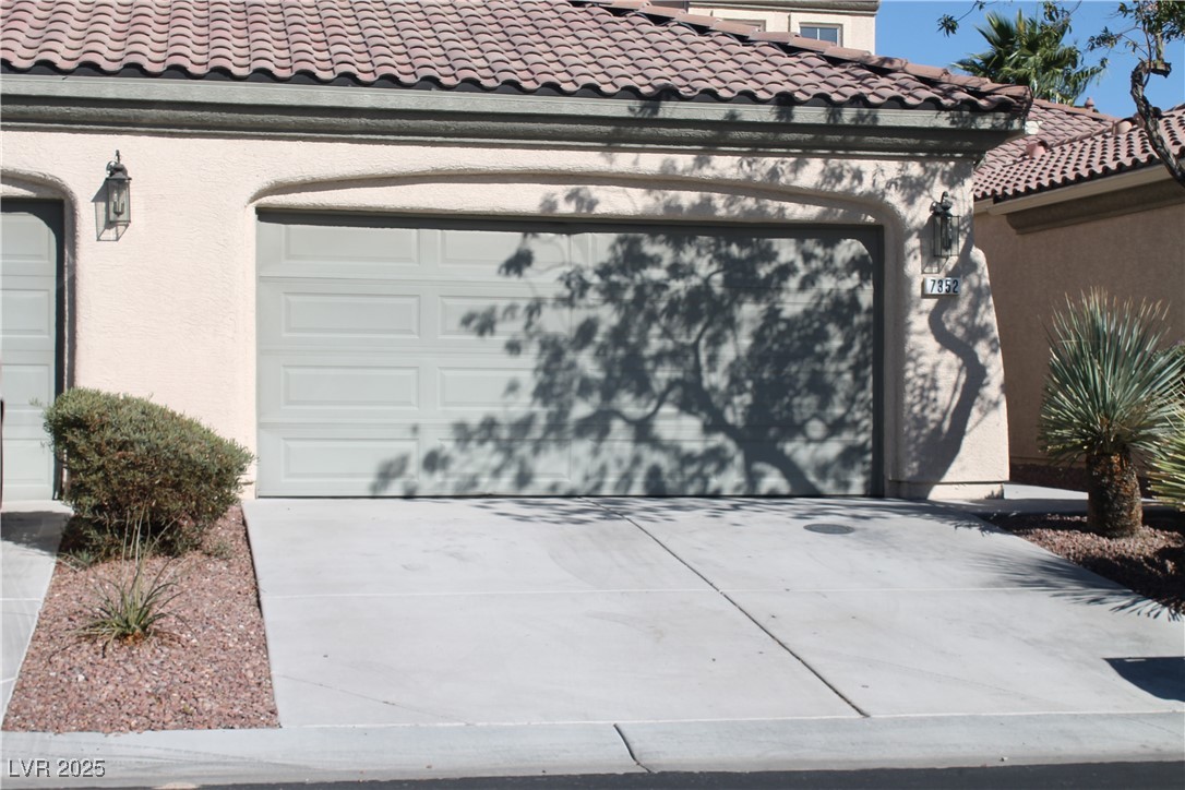 7352 Ravines Avenue Las Vegas, NV 89131 - Photo 47 of 93 Garage with concrete driveway