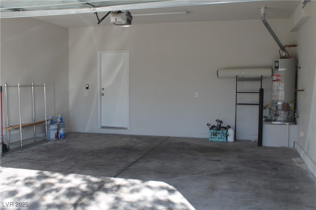7352 Ravines Avenue Las Vegas, NV 89131 - Photo 49 of 93 Garage with strapped water heater and a garage door opener