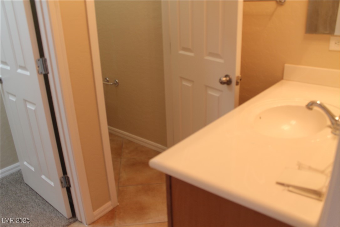 7352 Ravines Avenue Las Vegas, NV 89131 - Photo 56 of 93 Bathroom featuring vanity and light tile patterned flooring