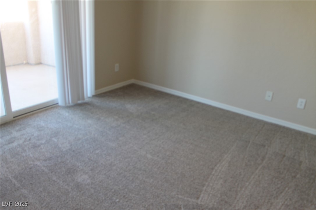 7352 Ravines Avenue Las Vegas, NV 89131 - Photo 61 of 93 Empty room with carpet flooring and baseboards