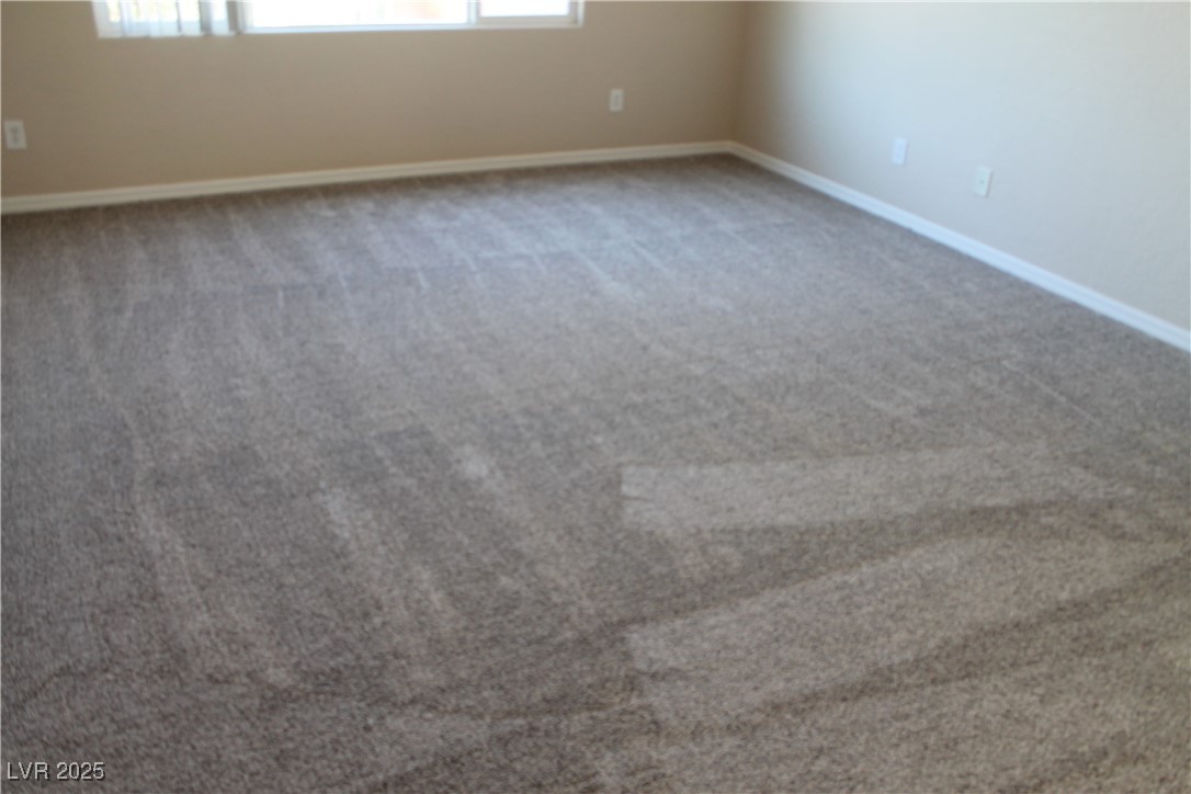 7352 Ravines Avenue Las Vegas, NV 89131 - Photo 64 of 93 Unfurnished room with light colored carpet and baseboards
