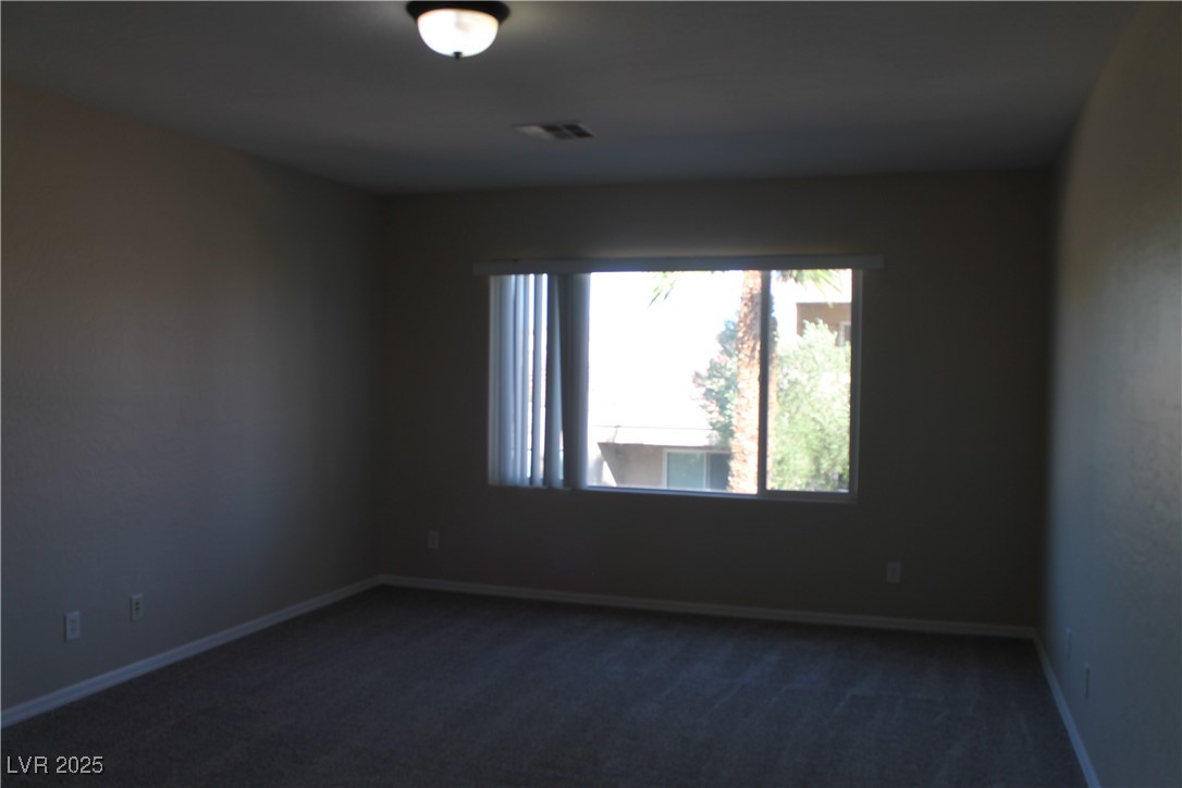 7352 Ravines Avenue Las Vegas, NV 89131 - Photo 66 of 93 Unfurnished room with dark carpet and baseboards