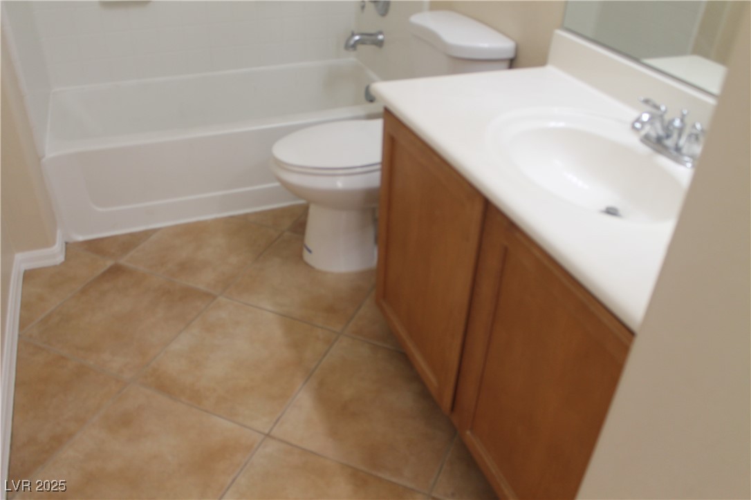7352 Ravines Avenue Las Vegas, NV 89131 - Photo 68 of 93 Full bath with light tile patterned flooring, vanity, and bathtub / shower combination