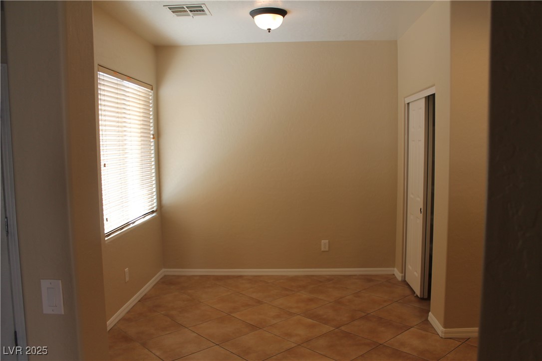 7352 Ravines Avenue Las Vegas, NV 89131 - Photo 7 of 93 Empty room with light tile patterned floors and baseboards