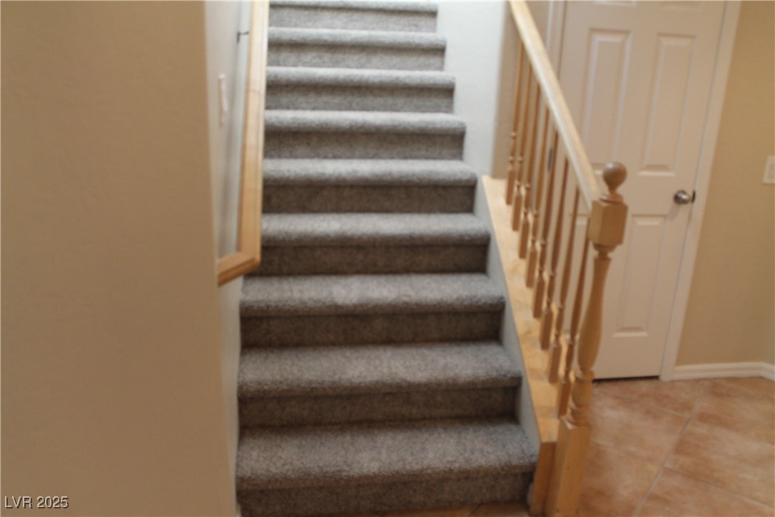 7352 Ravines Avenue Las Vegas, NV 89131 - Photo 76 of 93 Staircase featuring tile patterned floors and baseboards