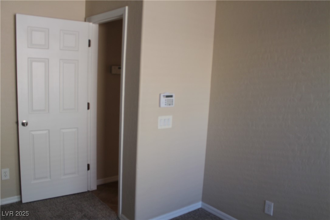 7352 Ravines Avenue Las Vegas, NV 89131 - Photo 81 of 93 Unfurnished room with baseboards and dark colored carpet