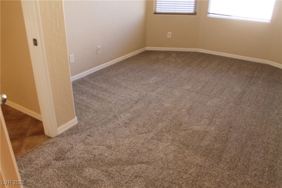 7352 Ravines Avenue Las Vegas, NV 89131 - Photo 83 of 93 Tiled empty room featuring baseboards and carpet floors