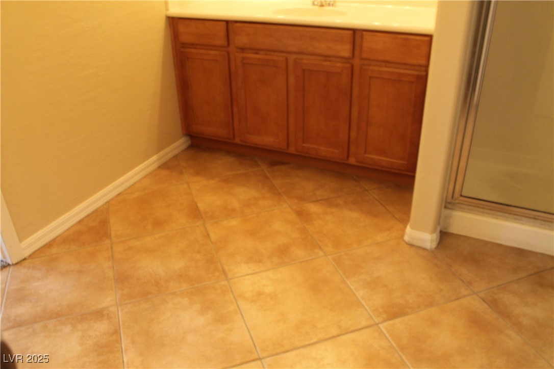 7352 Ravines Avenue Las Vegas, NV 89131 - Photo 87 of 93 Bathroom featuring vanity, a stall shower, and light tile patterned floors