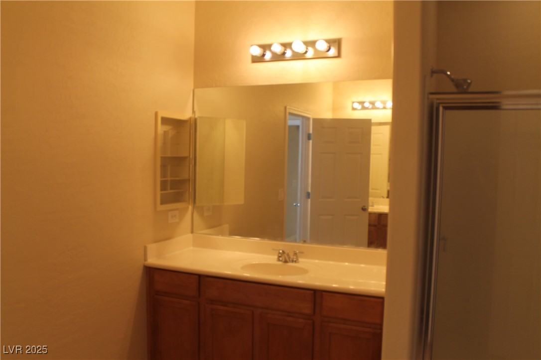 7352 Ravines Avenue Las Vegas, NV 89131 - Photo 88 of 93 Full bathroom featuring vanity and a shower