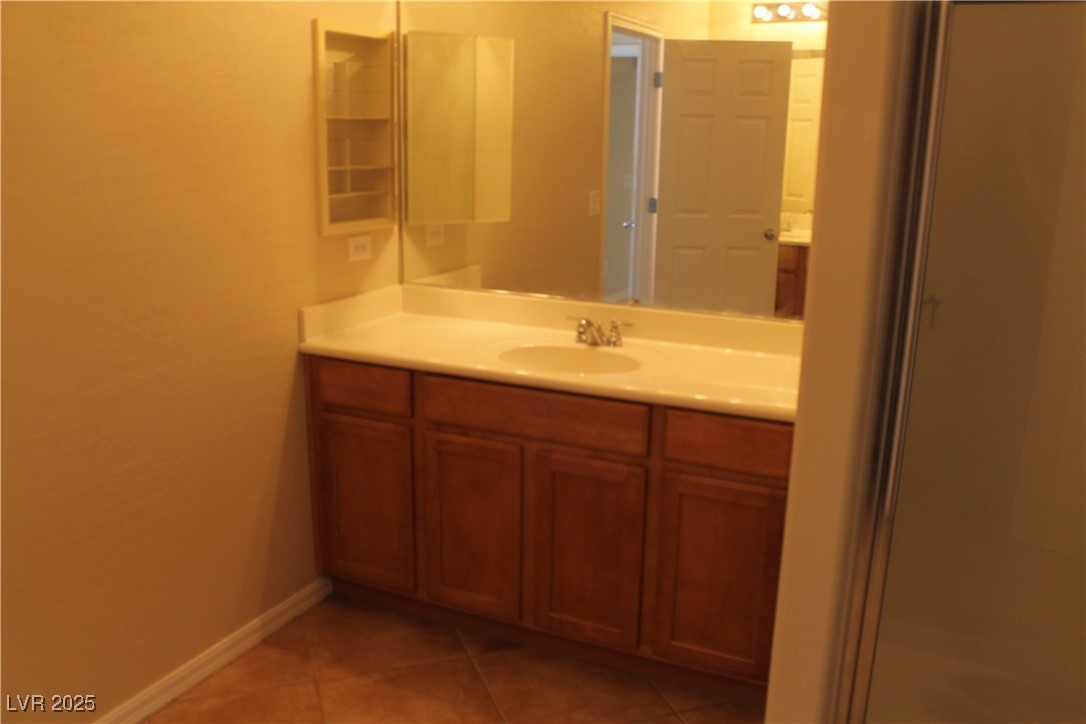 7352 Ravines Avenue Las Vegas, NV 89131 - Photo 89 of 93 Bathroom with vanity and light tile patterned flooring