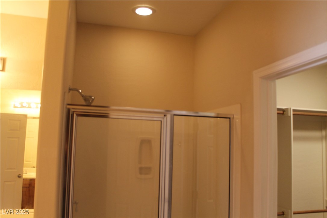 7352 Ravines Avenue Las Vegas, NV 89131 - Photo 90 of 93 Bathroom featuring a stall shower, vanity, and recessed lighting