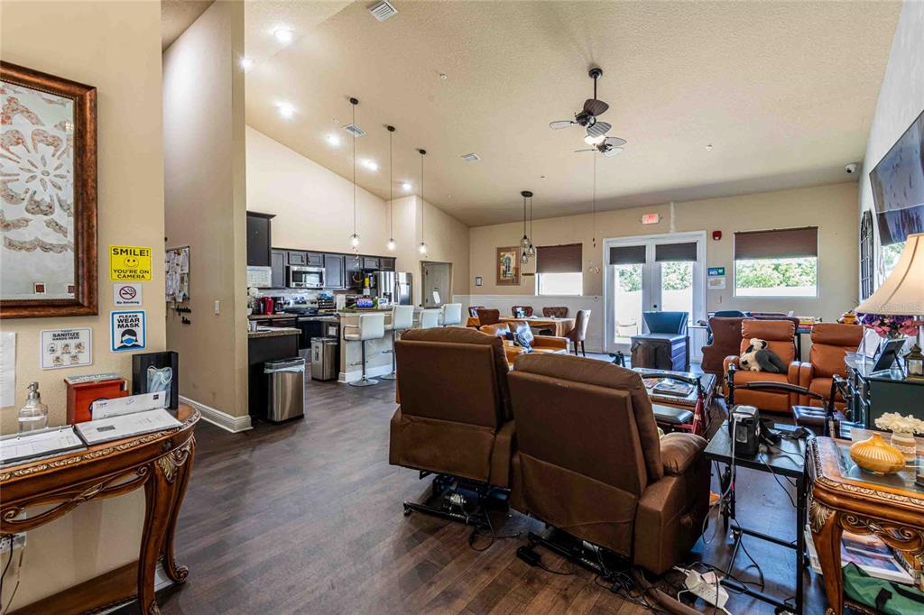 Undisclosed Address Spring Hill, FL 34608 - Photo 7 of 39 a living room with lots of furniture and kitchen view