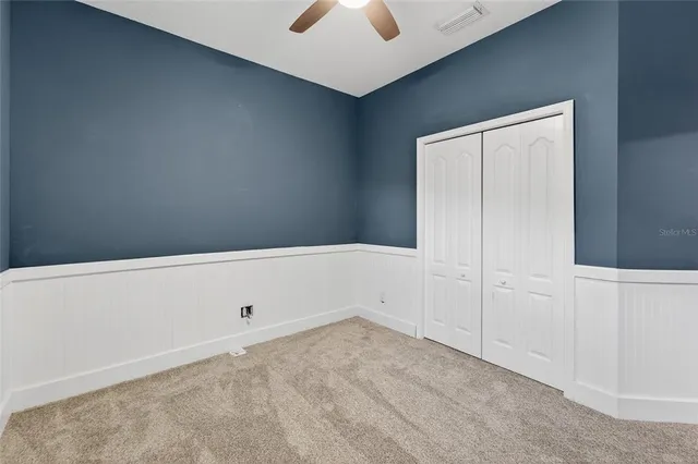 a view of a house with backyard and trees