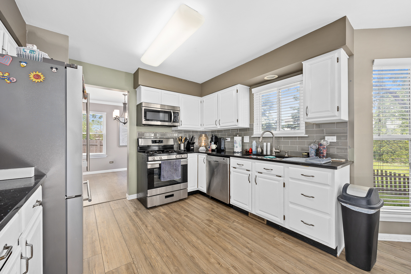 2 Buckboard Court Bolingbrook, IL 60490 - Photo 15 of 33 a kitchen with stainless steel appliances a stove top oven a sink a refrigerator a center island and a window