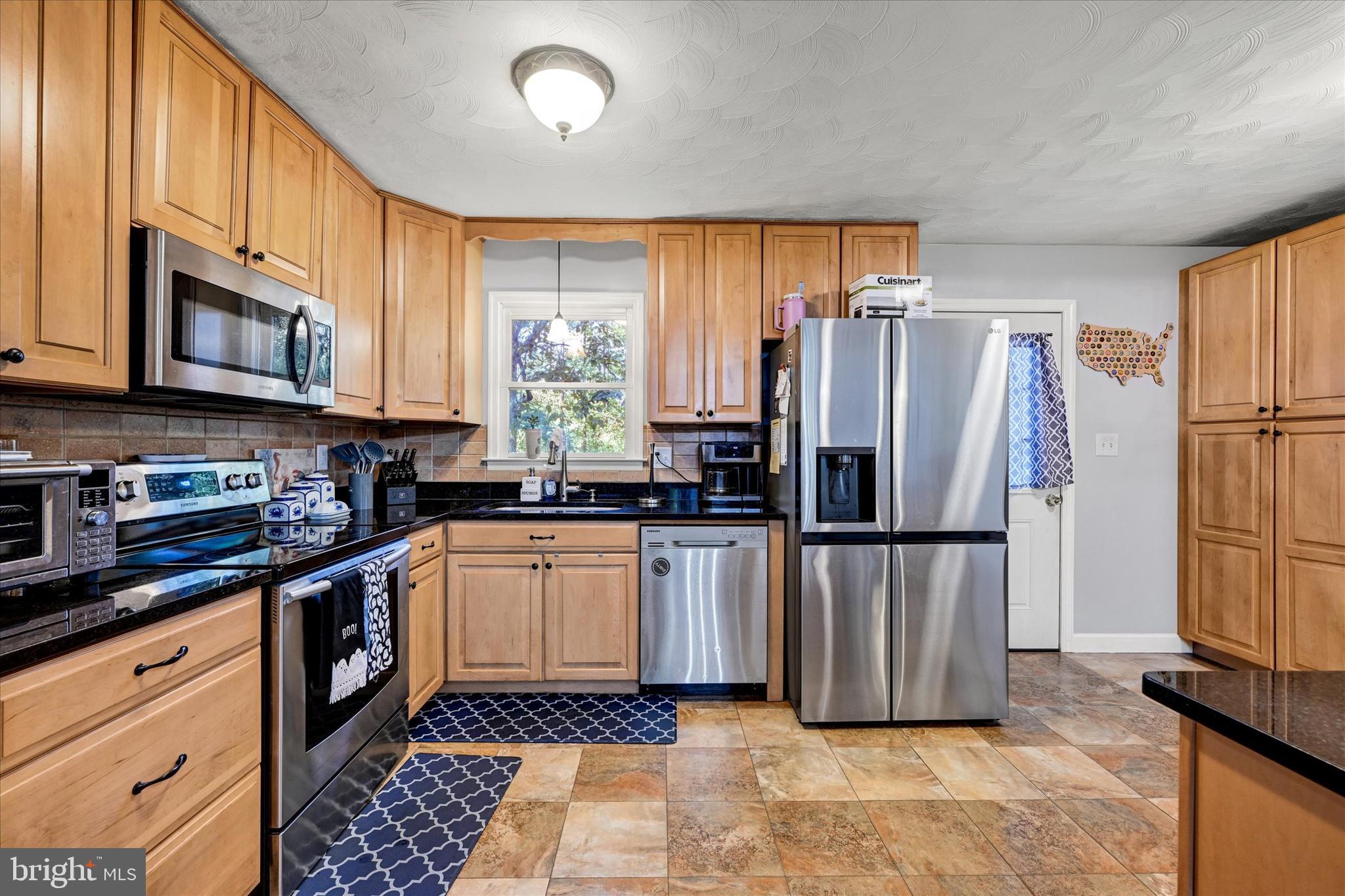 20 Houcksville Road South Hampstead, MD 21074 - Photo 5 of 37 a kitchen with stainless steel appliances granite countertop a refrigerator stove microwave and sink