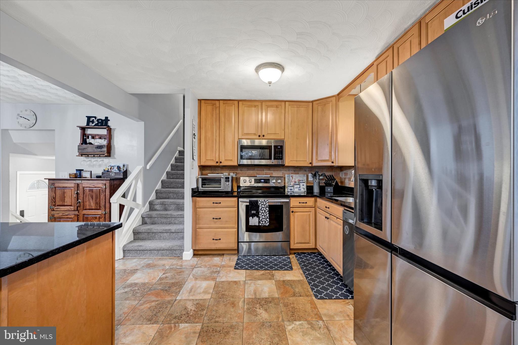 20 Houcksville Road South Hampstead, MD 21074 - Photo 7 of 37 a kitchen with stainless steel appliances granite countertop a refrigerator and a stove top oven