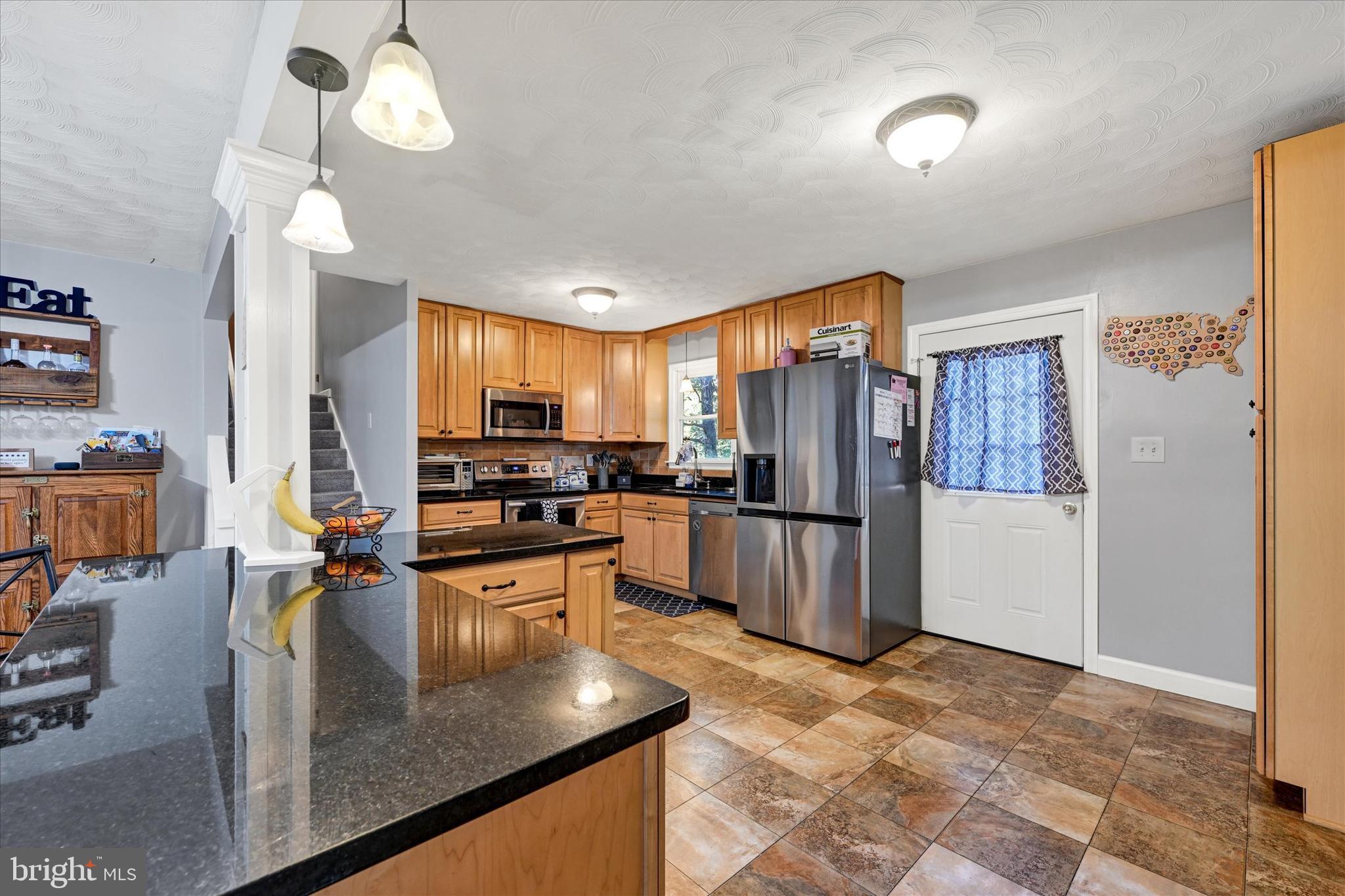 20 Houcksville Road South Hampstead, MD 21074 - Photo 8 of 37 a kitchen with stainless steel appliances granite countertop a refrigerator a stove oven a sink dishwasher and white cabinets with wooden floor