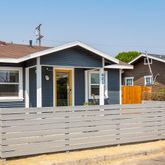 a view of house with yard outdoor seating