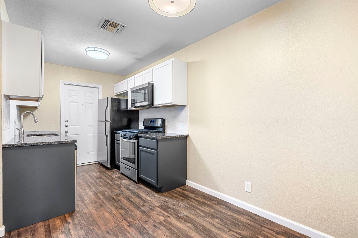 401 Blackson Avenue, Unit A Austin, TX 78752 - Photo 7 of 29 Kitchen with freshly painted cabinets. Stainless steel appliances.